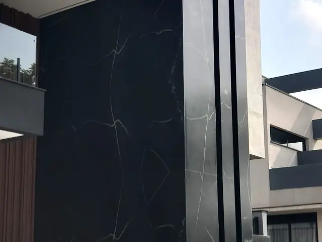Fachada com painel de pedra escura